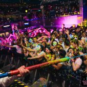 Luminosity UV paint party tour in action squirting paint in a nightclub