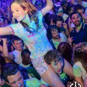 Girl on shoulders covered in uv paint at a nightclub uv paint party