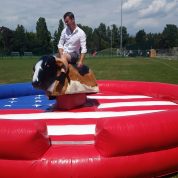 man riding uk mechanical rodeo bull