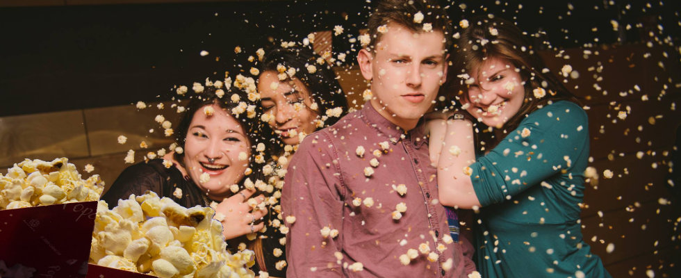 customers being showered with popcorn at a popcorn party